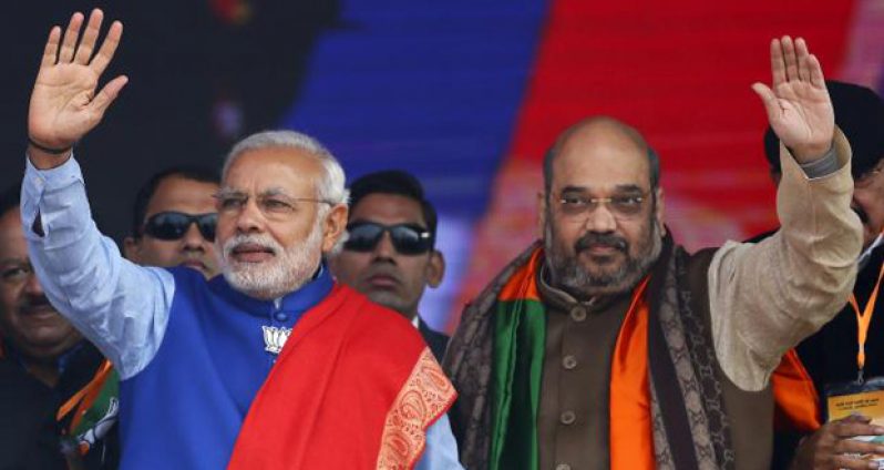 Indian Prime Minister Narendra Modi (L) and Amit Shah, the president of India's ruling Bharatiya Janata Party (BJP), wave to their supporters during a campaign rally ahead of state assembly elections at Ramlila ground in New Delhi, India, in this January 10, 2015 file photo.