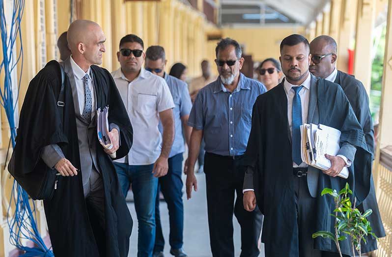 Nazar and Azruddin Mohamed leaving the High Court in Demerara accompanied by their legal team following the refusal of their application to stay extradition proceedings (Delano Williams photo)