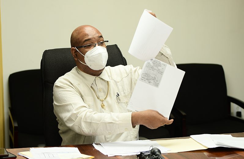 Minister of Public Works Juan Edghill shows documents  indicating that agencies which fell under the purview of the then Ministry of Public Infrastructure had purchased expensive gifts for former Minister David Patterson (Adrian Narine photo)