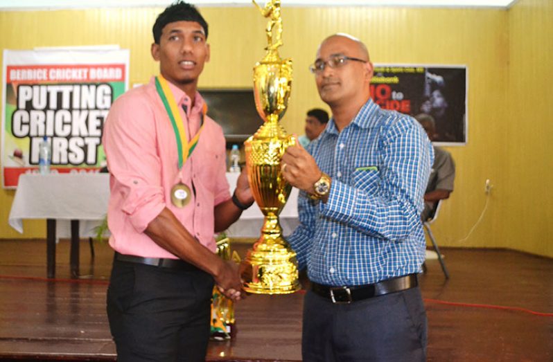 Guest Speaker of the BCB Award Ceremony, Attorney-at-Law Arudranauth Gossai, presents the Internationl Cricketer of the year award to Gudakesh Motie who received the award on behalf of Devendra Bishoo who is on West indies duties.