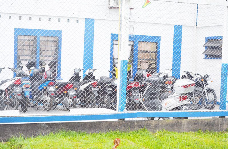 A section of the GPF’s Traffic Department with motorbikes in front.