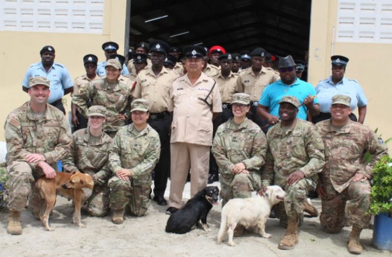 Superintendent, Rudolph Banwari (centre) flanked by personnel from US Air Force Public Affairs Agency and ranks of the Canine and Mounted branches