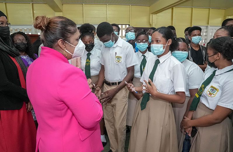 Education Minister Priya Manickchand interacts with some of the affected CSEC students