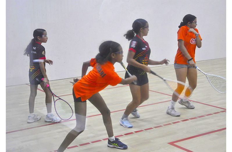 Tehani Munroe (2nd left) executes a powerful forehand shot in the Girls Doubles on Wednesday evening at the NRC