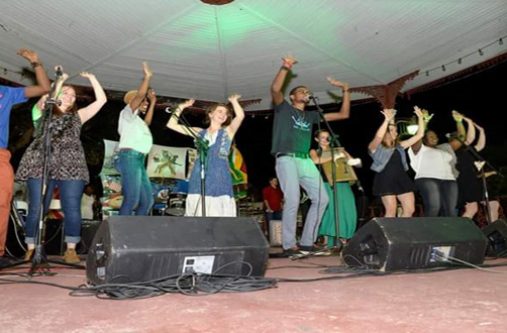 A batch of students from Music Unlimited’s voice training classes performing with the Grammy-nominated group, Della Mae during their visit to Guyana