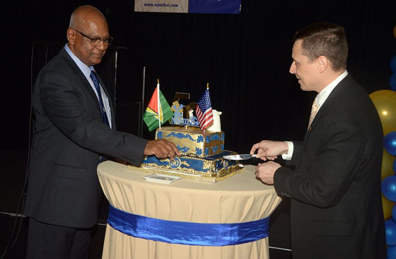 Managing Director of NAMILCO, Roopnarine Sukhai, and Deputy Chief of Mission for the US Embassy, Terry Steers-Gonzalez, cutting the ceremonial cake to commemorate the 50th Anniversary (Adrian Narine photo)