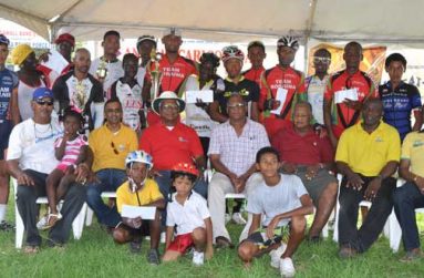 Prize winners of the various categories of the NAMILCO-sponsored Annual CARICOM 13-race cycle programme strike a pose with event organisers and sponsors yesterday, at the Seawall Bandstand.