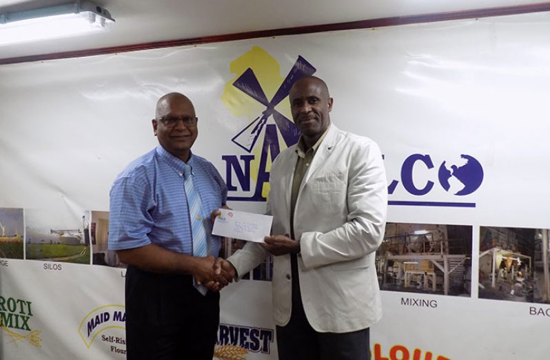 NAMILCO's Managing Director Bert Sukhai (L) hands over sponsorship cheque to GFF acting president Brigadier (ret.) Bruce Lovell.