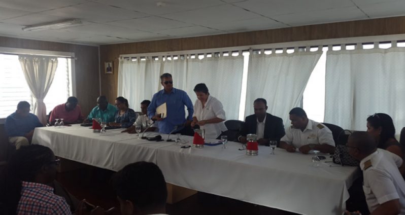 President of NATA, Annette Arjoon-Martins, and Chief Executive of Roraima Airways Inc, Captain Gerry Gouveia (standing) are flanked by NATA board members during their maiden press conference yesterday