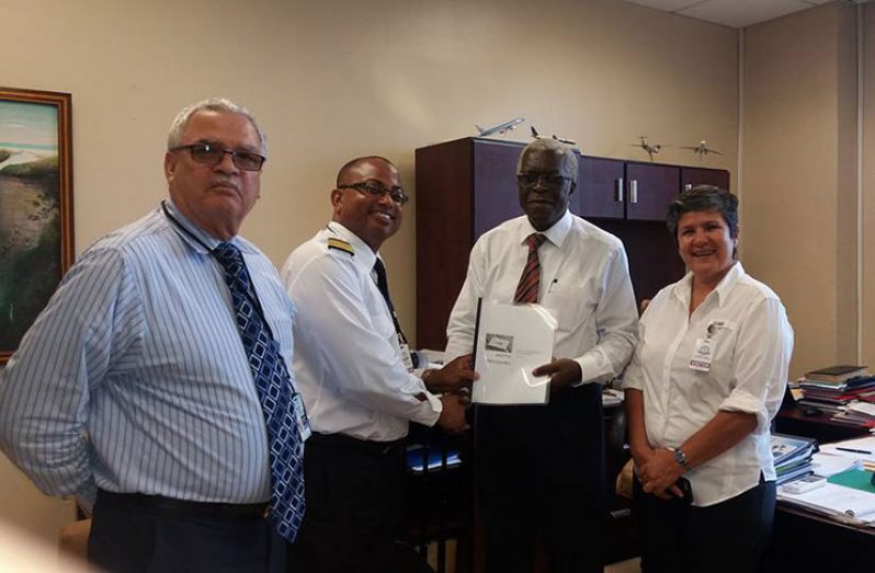 Representatives of NATA submit their shuttle procedures to Director-General GCAA Lt. Col. (ret'd) Egbert Fields on Thursday (Learie Constantine Barclay photo)