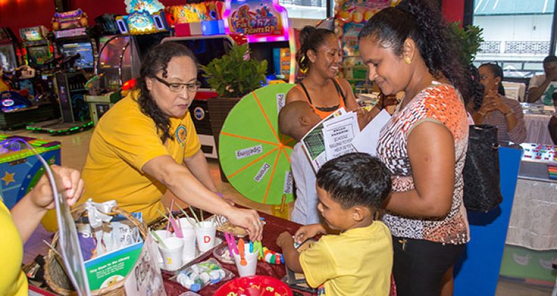 A child and his parent at the literacy clinic at Fun City, Ramada Princess Hotel on Sunday