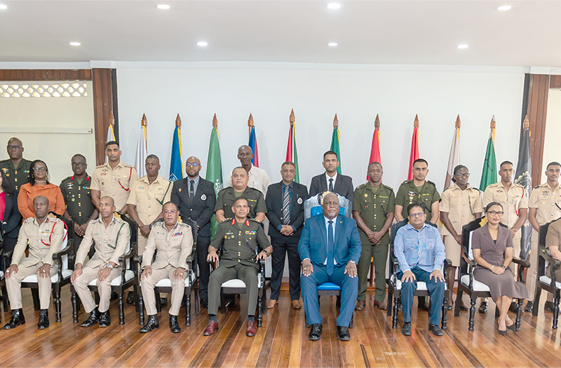 Prime Minister, Brigadier (Ret’d) Mark Phillips (fourth from right) and Chief of Defence Staff Brigadier Omar Khan (fifth from left), flanked by government ministers and other heads of the joint services along with participants of the newly launched Certificate in Defence Studies programme (Delano Williams photos)