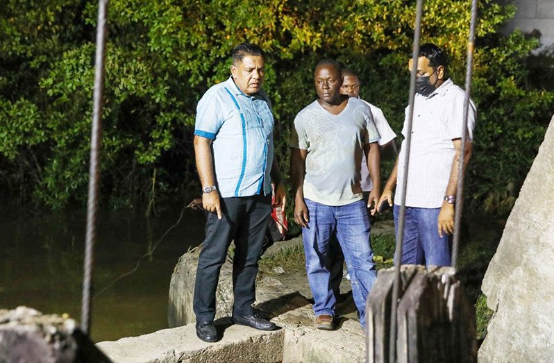 Agriculture Minister Zulfikar Mustapha and team inspecting the sluice at Cowan Street, in Georgetown, on Friday night (DPI photo)