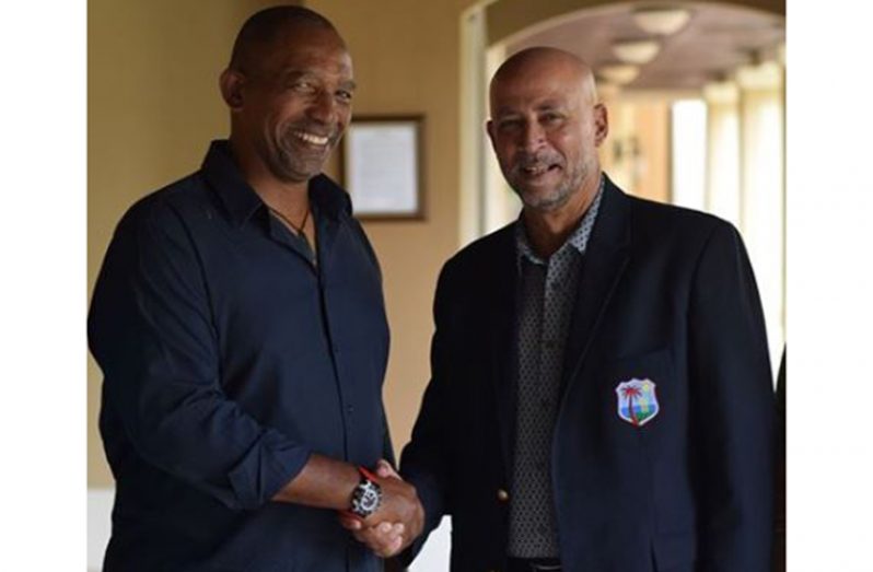 Newly appointed head coach Phil Simmons is congratulated by  CWI president Ricky Skerritt.(CWI photo)