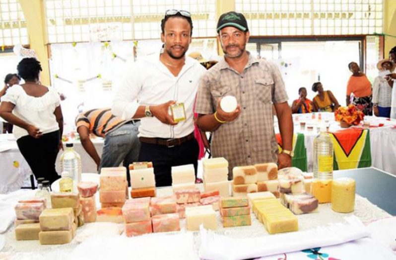 Linden farmer and agro-processor Owen-DeSouza along with MP Jermaine Figuiera proudly displays some of his locally-produced soaps