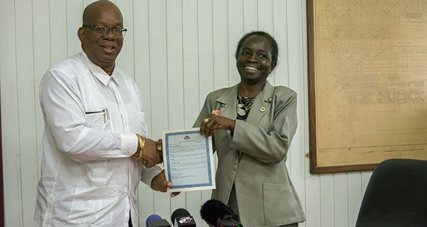 Finance Minister, Winston Jordan and NIS General Manager, Doreen Nelson after signing  the agreement