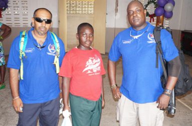 Trinidadian’s Award Training Director left, Mr. Timmy Temal, NOC Inmate Granville Odle and Mr. Amafika Luke.
