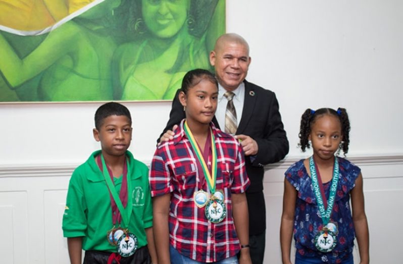 Minister of Social Cohesion with responsibility for Culture, Youth and Sport, Dr George Norton, along with (from left) Orlando Carrington, Annalee Williams and Somayia Orna. (DPI photo)