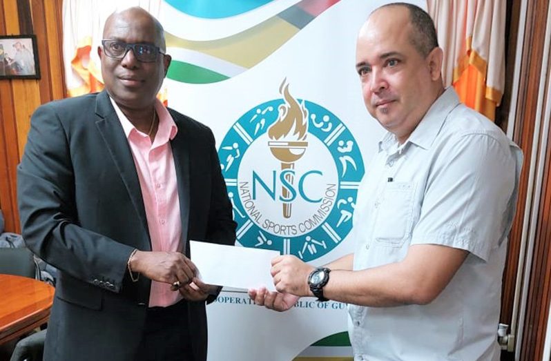 Director of Sport, Steve Ninvalle, makes the NSC’s contribution of $875 000 to GABF president Michael Singh
