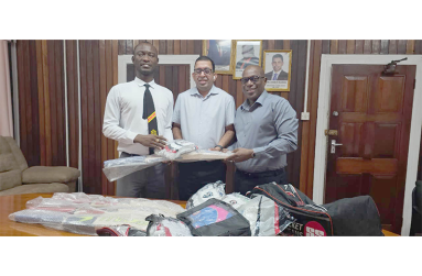 Director of Sports, Steve Ninvalle (right), presents gear to the National Blind Cricket Association’s Ganesh Singh (centre) and Leroy Phillips (left)