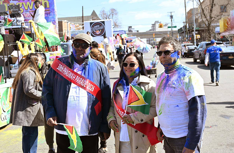 From left, Consul General to New York, Ambassador Michael E. Brotherson; Minister within the Ministry of Local Government and Regional Development, Pauline Sukhai and Investment and Diaspora Initiatives Head Fazil Joe Yussuff, joined the 38th annual Phagwah float parade, and cultural presentation at Phil Rizzuto Park on March 29, 2026 ( Caribbean Life photos)