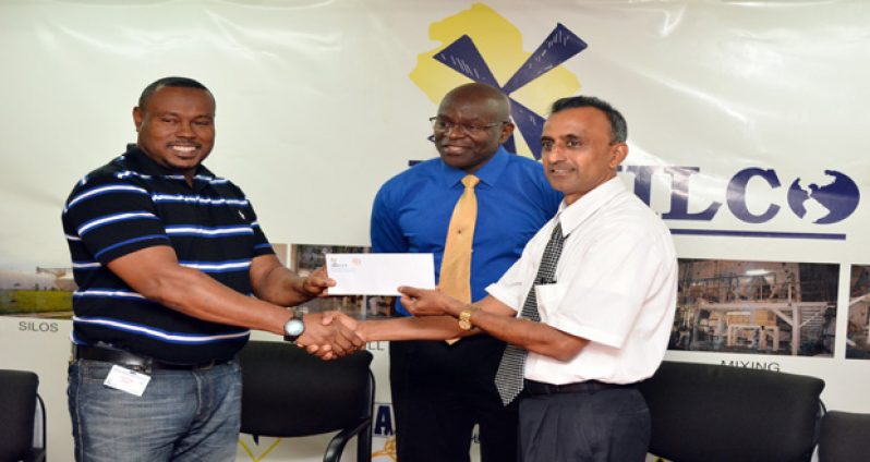 Petra Organisation’s Troy Mendonca, receives the sponsor’s cheque from NAMILCO’S Asst Managing Director Autamaram Lakeram while the company’s Chief Financial Officer Fitzroy McLeod looks on. (Samuel Maughn photo)