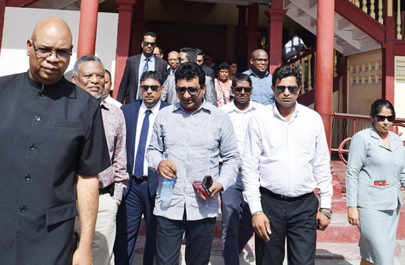 Nandlall flanked by lawyers and a supporter while leaving the Georgetown Magistrates Court (Cullen Bess-Nelson photo)