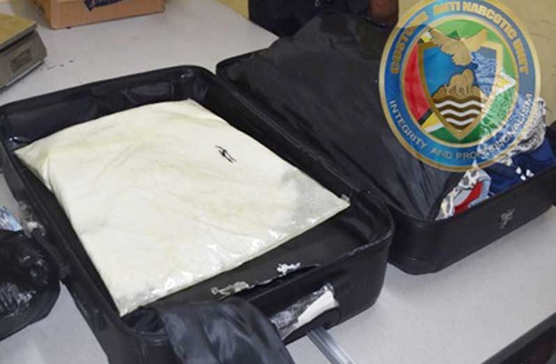 A black suitcase with a secret compartment held the suspected cocaine