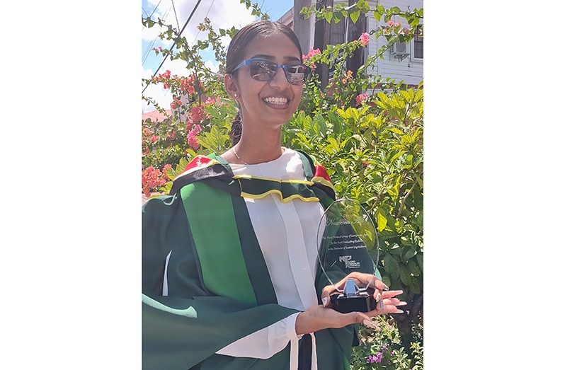 Nareema Alli proudly displays her UGBC award