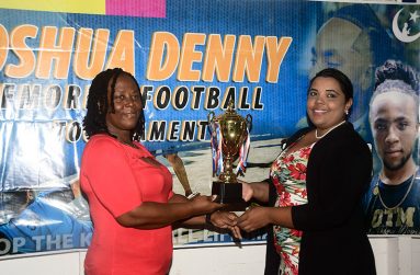 Mrs Aferya Denny (left) collecting the challenge trophy from Miss Nareesa Latif of the Petra Organisation