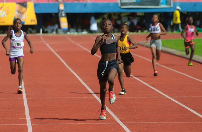 East Coast’s Marissa Thomas heads in for the win in the Girls’ Under-10 400m, as District 10’s Adessa Albert (right) fights her way to second place. (Delano Williams photo)