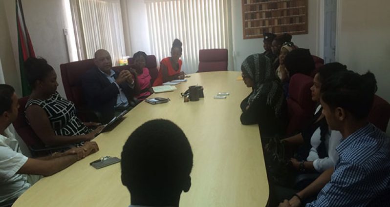 Natural Resources Minister Raphael Trotman in discussion with the young achievers and their parents