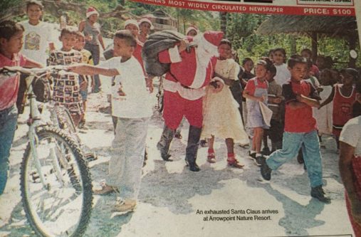 An exhausted Santa Claus arrives at Arrowpoint bearing gifts for children of Amerindian communities (December 23, 2003)
