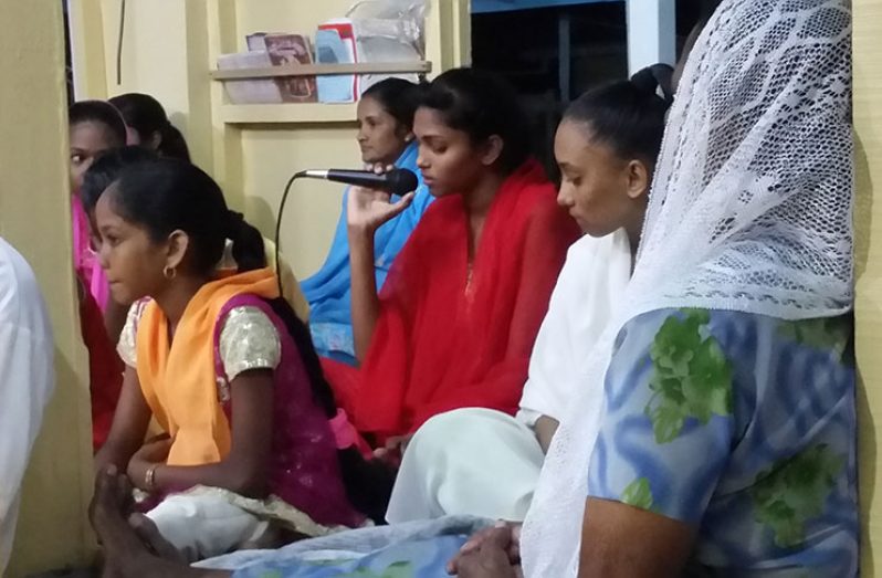 A member of the Golden Fleece Mandir performs a song at the Navratri observance