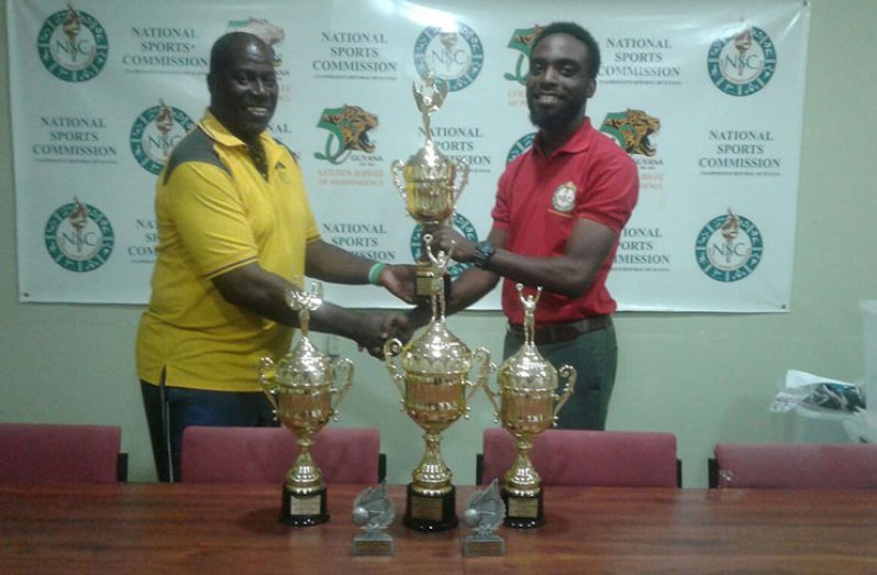BVA president Mr Levi Nedd receives trophies for the BVA inter-school tournament from Assistant Director of Sport Brian Smith.