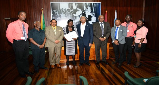 Newly-sworn in Minister within the Ministry of Communities Valerie Adams-Patterson (Fourth from left) flanked by President David Granger and Prime Minister Moses Nagamootoo and other cabinet colleagues and relatives