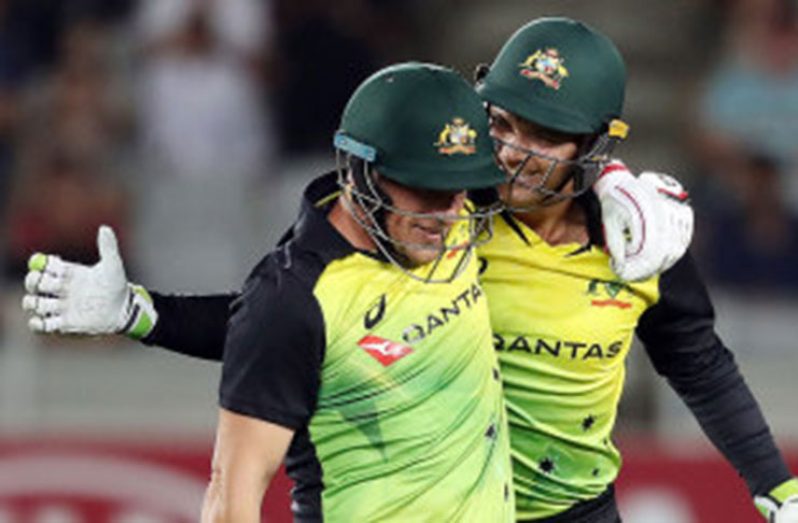 Aaron Finch and Alex Carey celebrate Australia's record-breaking win  AFP