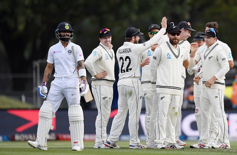 New Zealand get together to celebrate Virat Kohli's wicket © Getty Images