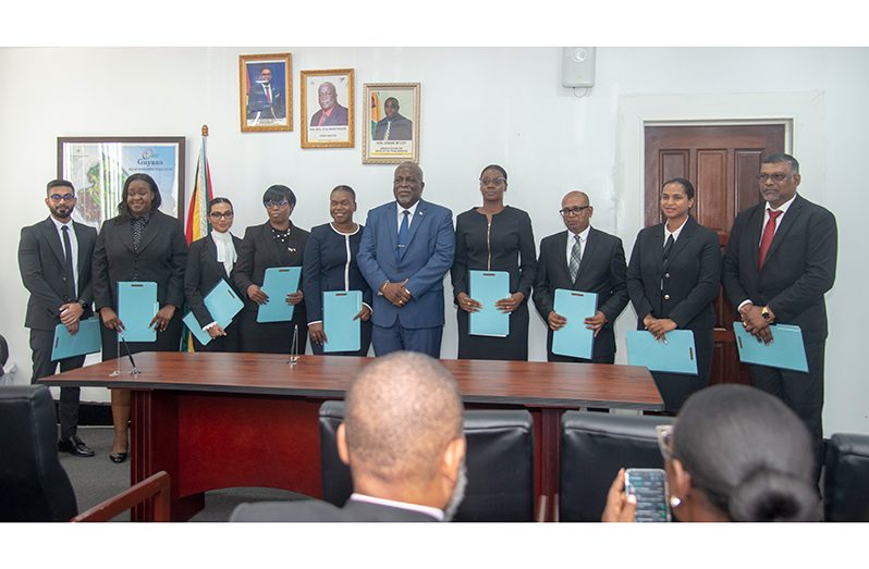 From L-R: Teriq Mohammed, Tuanna Hardy, Shivani Lalaram, Michelle Matthias, Tamieka Clarke, Prime Minister Mark Phillips, Abigail Gibbs, Omadatt Chandan, Orinthia Schmidt and Ravindra Mohabir