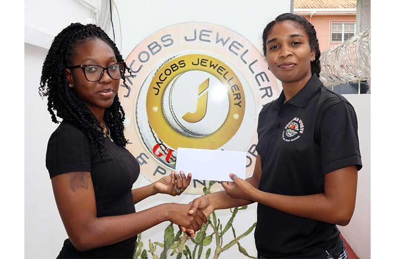 Nidia Andrews (right) receiving a contribution from Jacobs Jewellery.