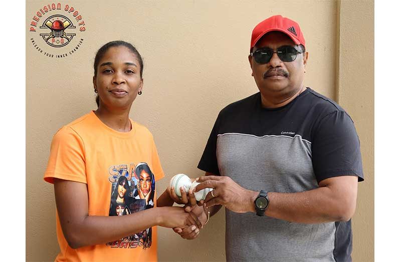 Nidia Andrews, left, receives the balls from Anil Beharry