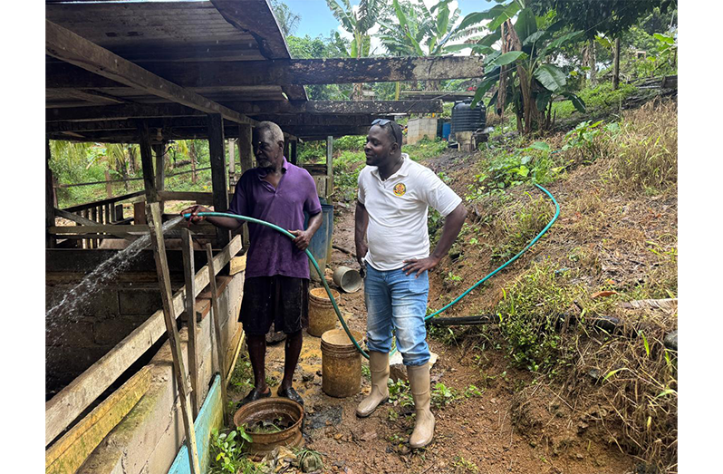 Swine farmer, Nigel Peters, and GLDA Extension staff, Alfred (only name given), during a visit to his farm