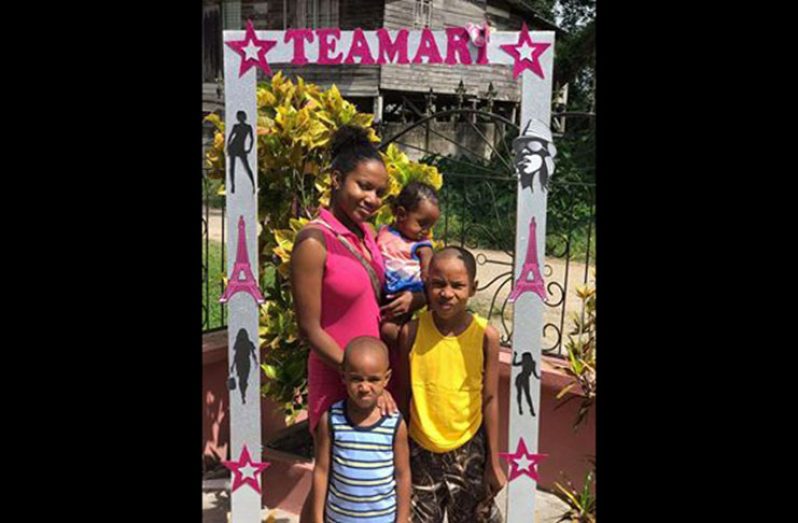 Nikisha and her three sons under a giant selfie frame she created