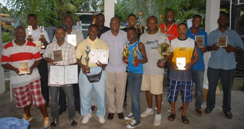 President of the Guyana Boxing Association (GBA) Steve Ninvalle (center) strikes a pose with the respective awardees who proudly display their spoils after receiving them yesterday. (Photo by Sonell Nelson)