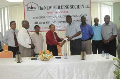 With executive members of both NBS and GCA looking on appreciatively, Chief Executive Officer Amad Khan (5th from left) presents the cheque to president of the GCA, Roger Harper. Also in picture is Chairman of NBS Floyd McDonald (3rddfrom left).