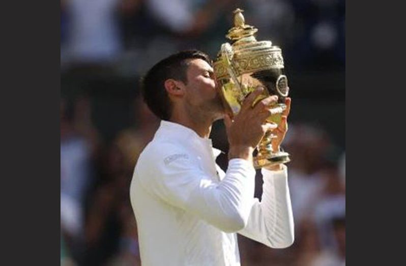 Serbia's Novak Djokovic celebrates with the Wimbledon trophy after winning the men's singles final against Australia's Nick Kyrgios REUTERS/Matthew Childs
