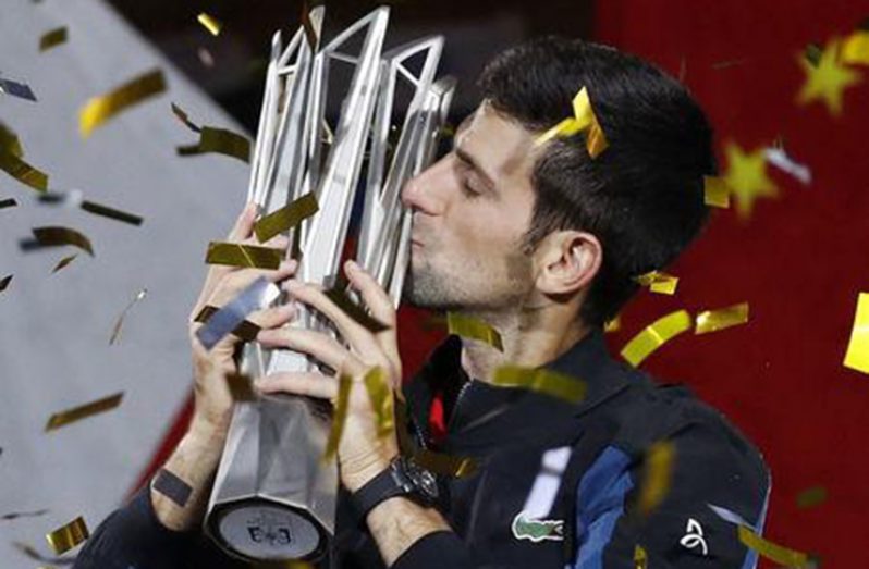 Novak Djokovic of Serbia celebrates with the trophy after winning the final against Borna Coric of Croatia. REUTERS/Aly Song