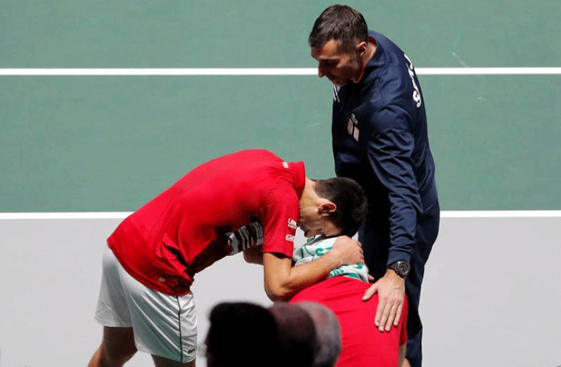 Serbia's Novak Djokovic and captain Nenad Zimonjic console Viktor Troicki after they lose their doubles match against Russia's Andrey Rublev and Karen Khachanov. (REUTERS/Susana Vera)