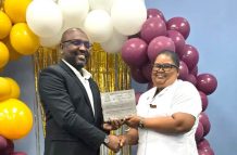 Adams receiving the ‘Best Midwife of Region Three’ award from Permanent Secretary of Ministry of Health, Malcolm Watkins