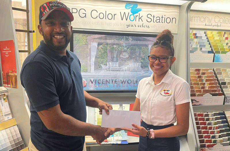 Shenell Ornella Rodrigues - Bumper To Bumper Services Associate hands over the sponsorship cheque to Nyron Maraj.